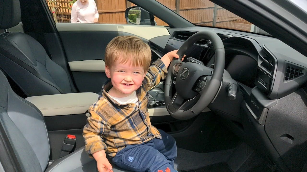 child in a Lexus RZ450e 