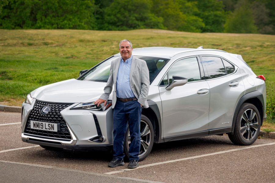 Lexus customer, Laurie Rosenberg. posing next to his Lexus UX.