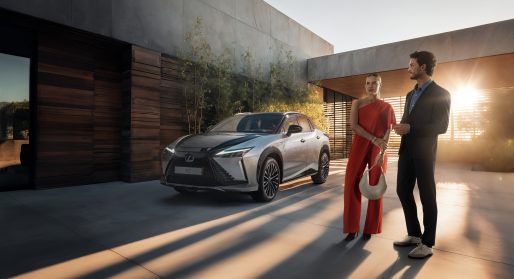 Lexus RZ with two people standing in front of car